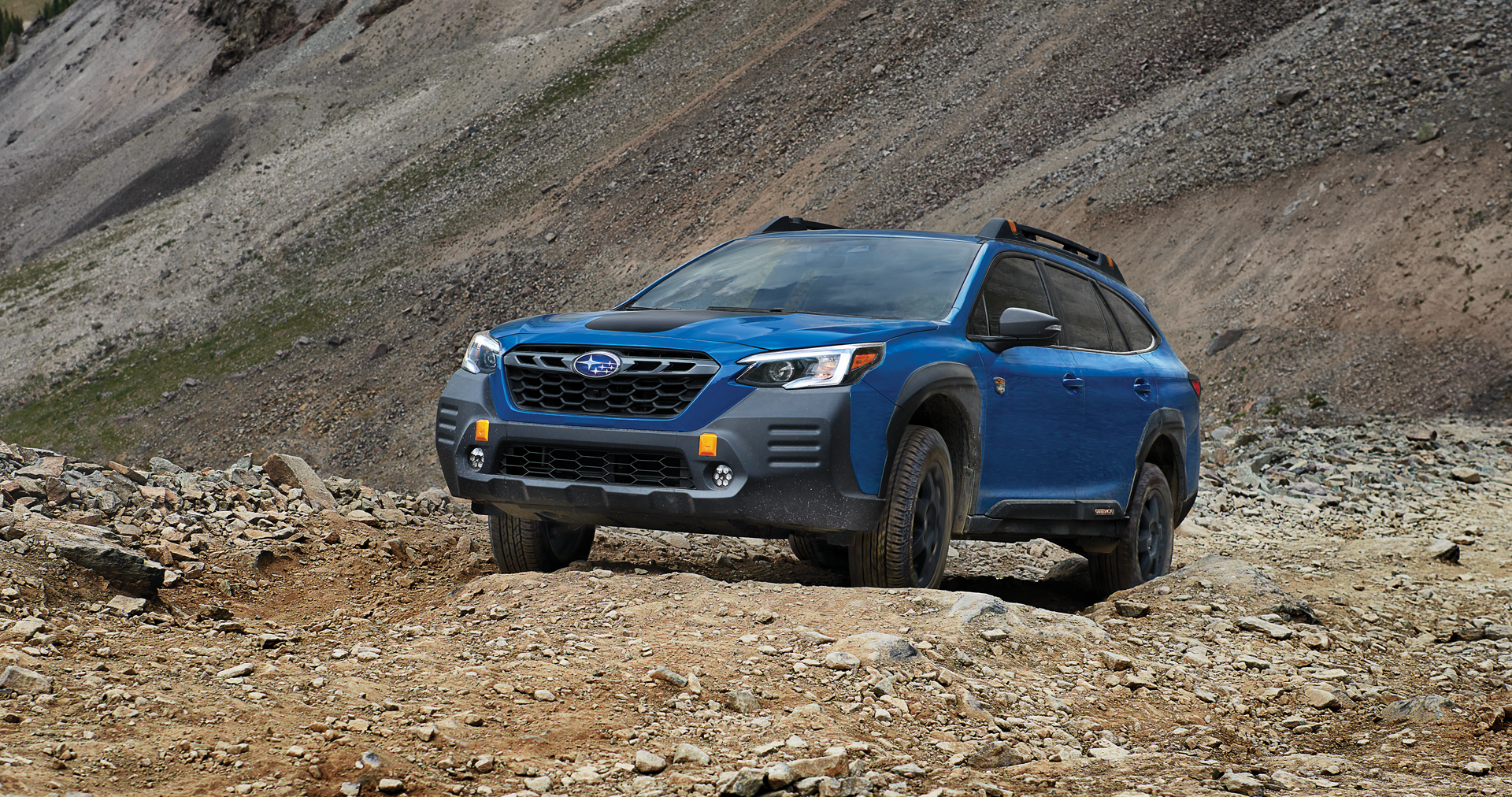 A 2023 Outback Wilderness driving on a trail in the mountains. | Subaru World of Newton in Newton NJ