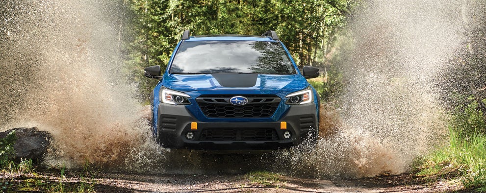 A 2023 Outback Wilderness driving on a muddy trail. | Subaru World of Newton in Newton NJ